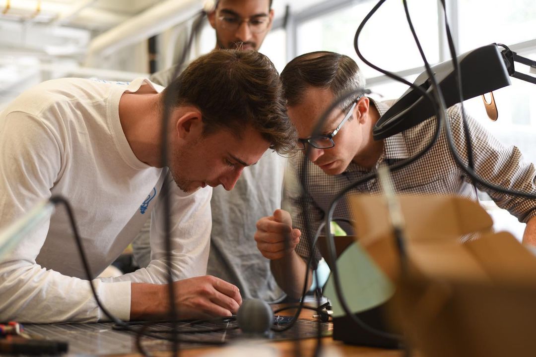 A very staged-looking (but actually wasn't staged) photo of me working with a student in the GWIC.